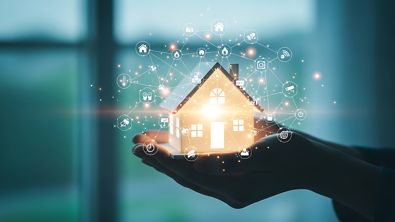 hand holding a glowing house